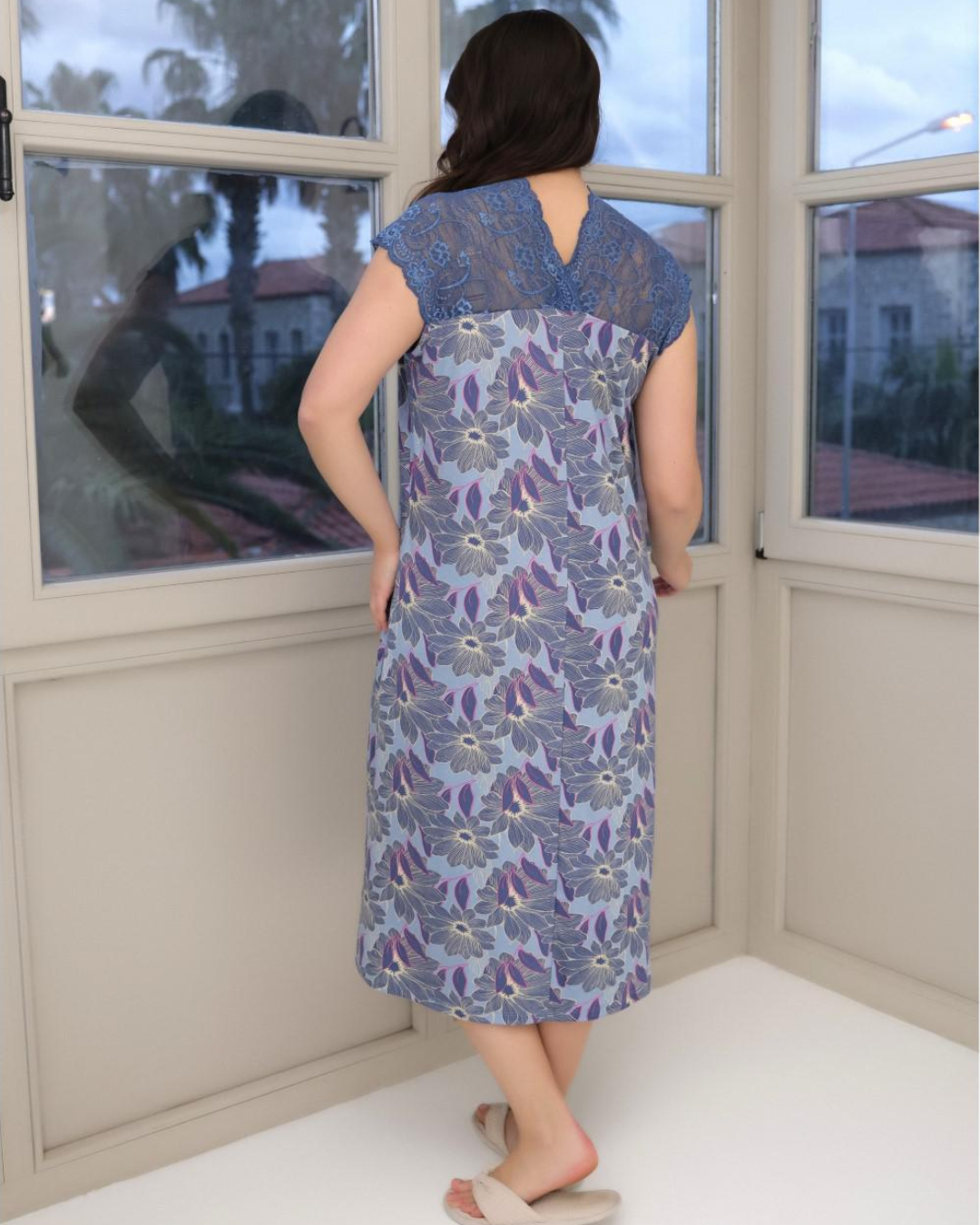 A short women's shirt with quarter sleeves and lace on the chest