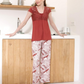 Women's pajamas with a quarter-sleeve t-shirt, lace on the chest, and floral trousers