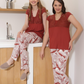 Women's pajamas with a quarter-sleeve t-shirt, lace on the chest, and floral trousers