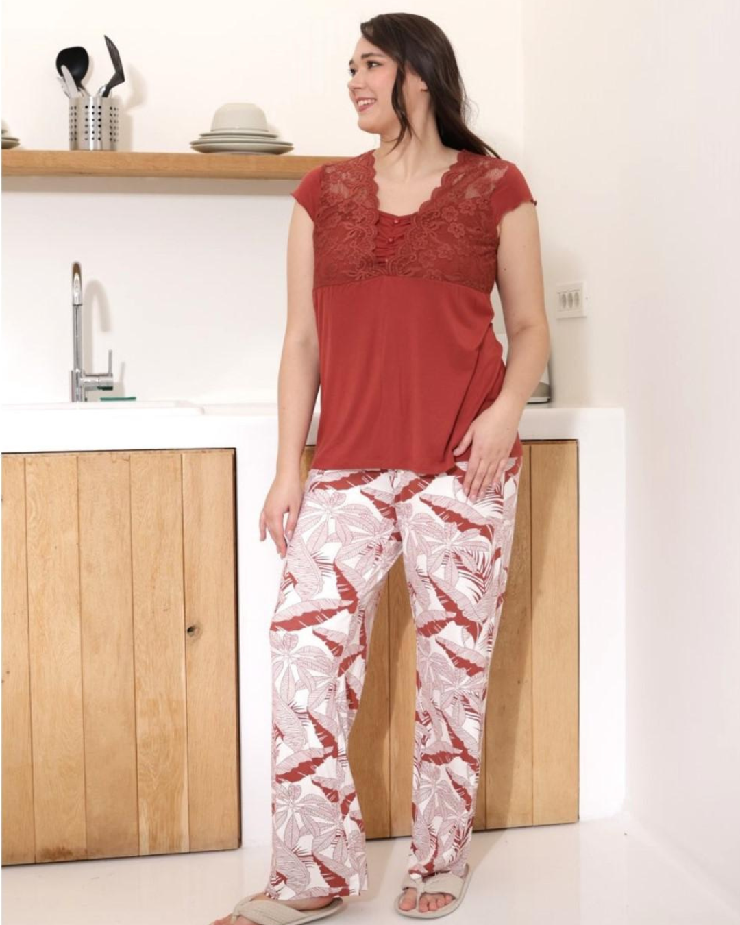 Women's pajamas with a quarter-sleeve t-shirt, lace on the chest, and floral trousers