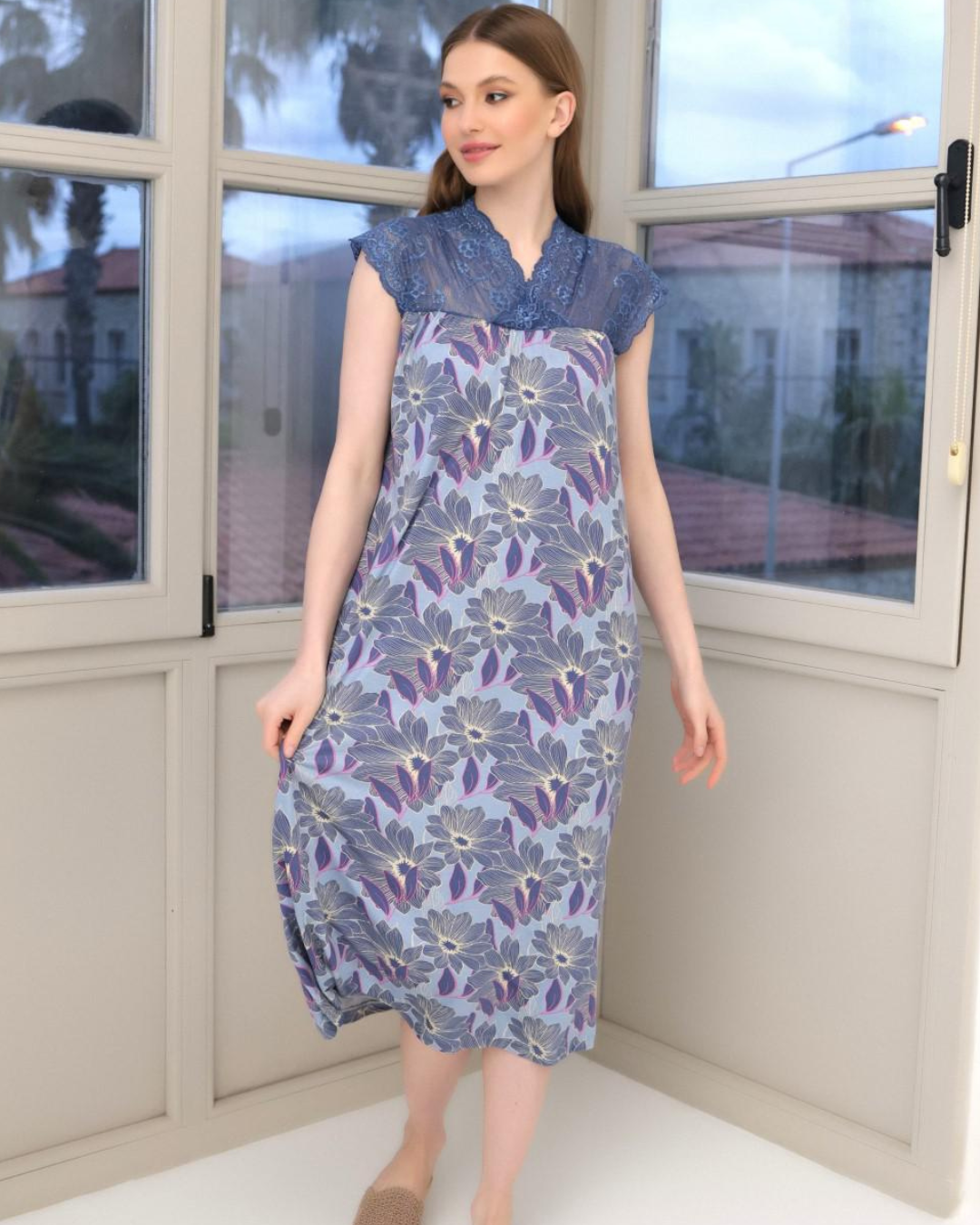 A short women's shirt with quarter sleeves and lace on the chest