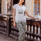 Women's pajamas with a half-sleeved top and a lace print and olive-rose trousers