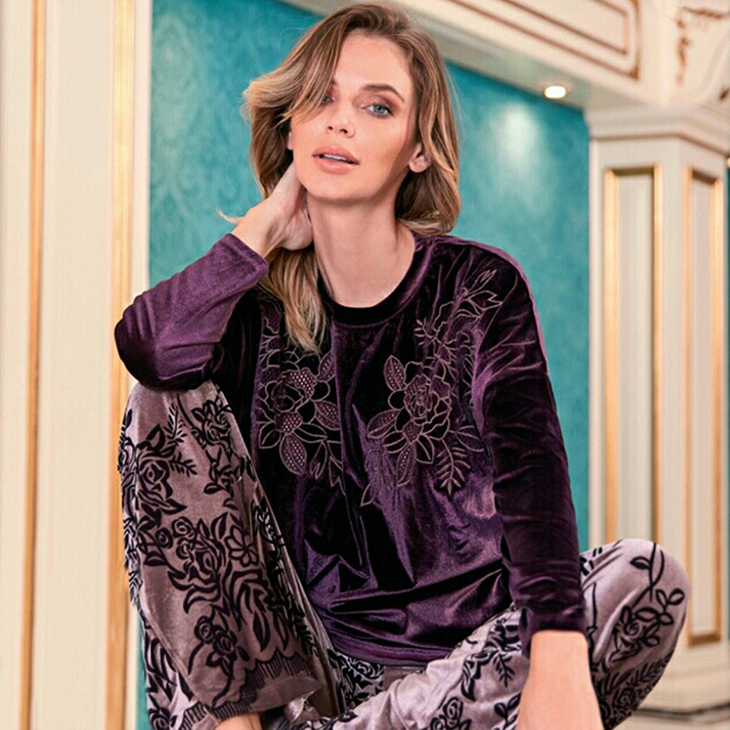 An embroidered velvet skirt with a rose on the chest